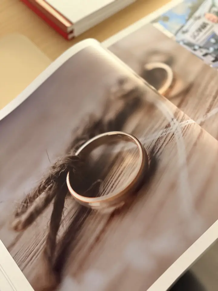 Page d'un livre photo : alliances posées sur le bois