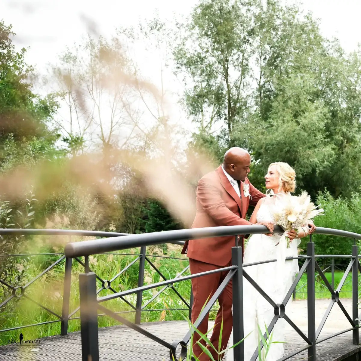 Les mariés sur un pont, entourés de verdure
